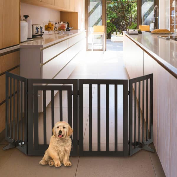 golden retriever puppy sitting in front of a gate in a kitchen